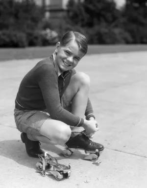 1930s Boy Fastening Metal Roller Skates